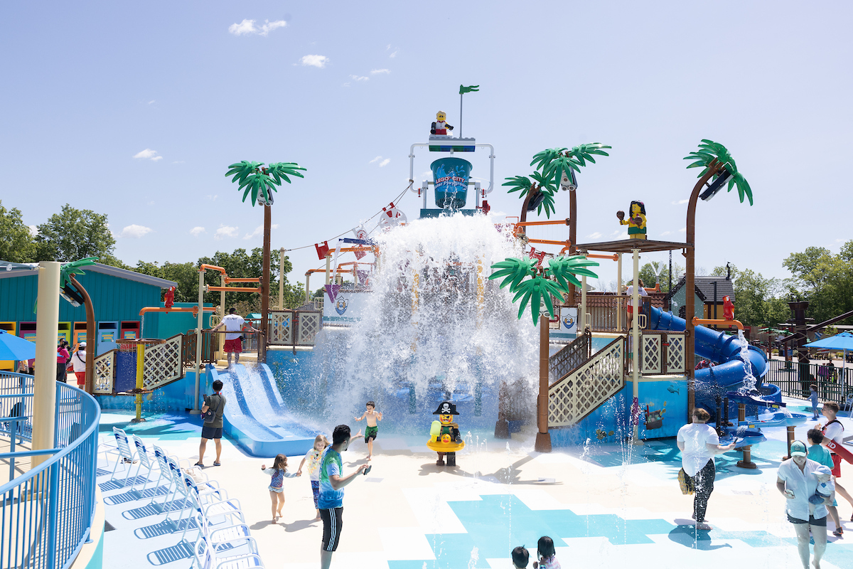 Großer Wasserspielplatz im LEGOLAND New York Resort mit Rutschen, Wasserfontänen und spielenden Kindern