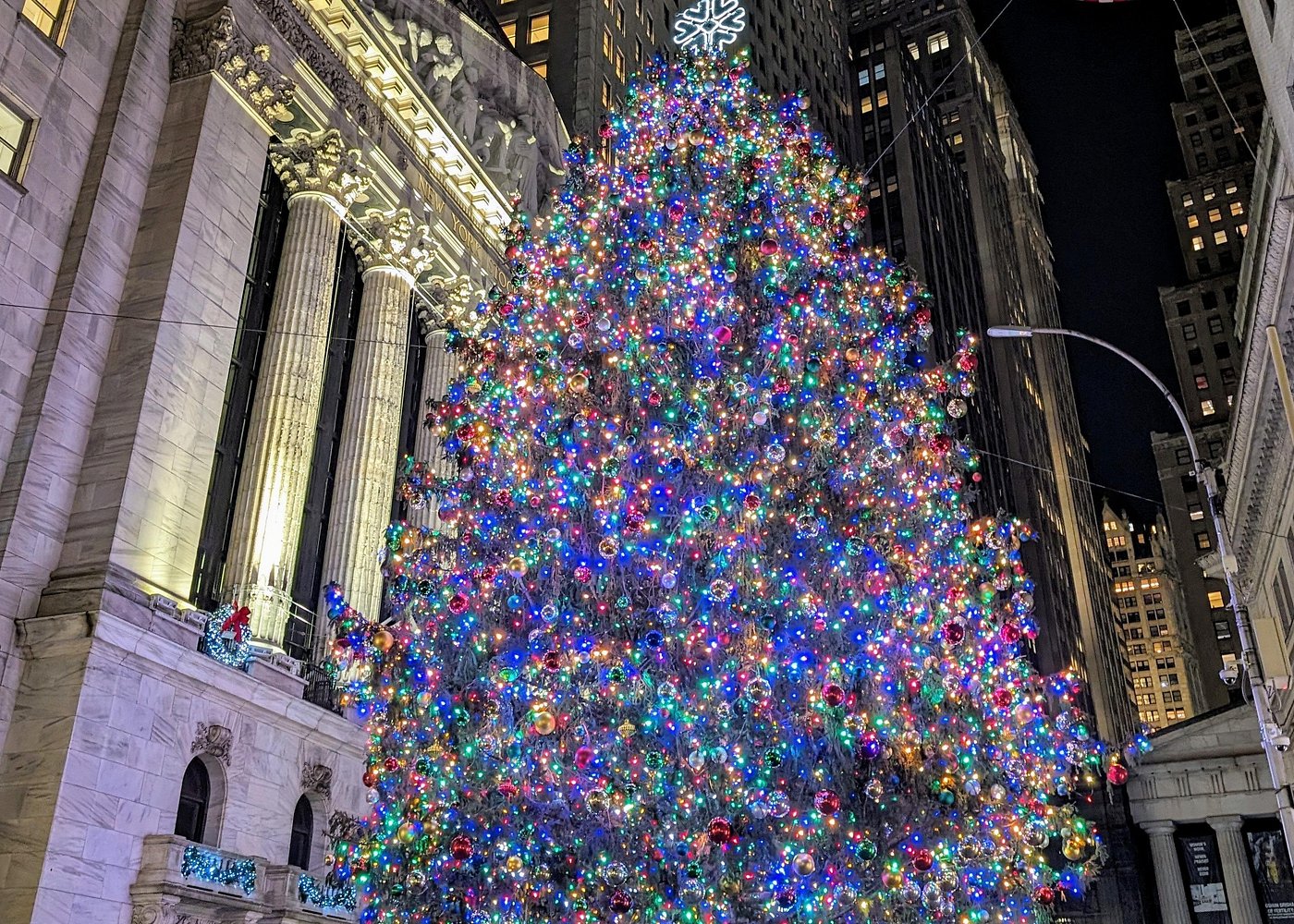 Großaufnahme des bunt beleuchteten Weihnachtsbaums vor der New York Stock Exchange in Manhattan.